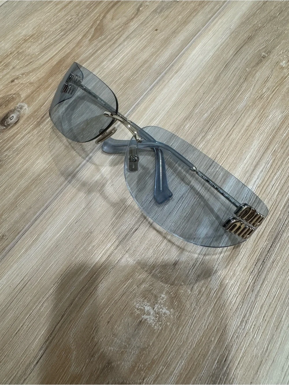 Miu Miu Light Blue Rimless Sunglasses with Gold Logo Accents